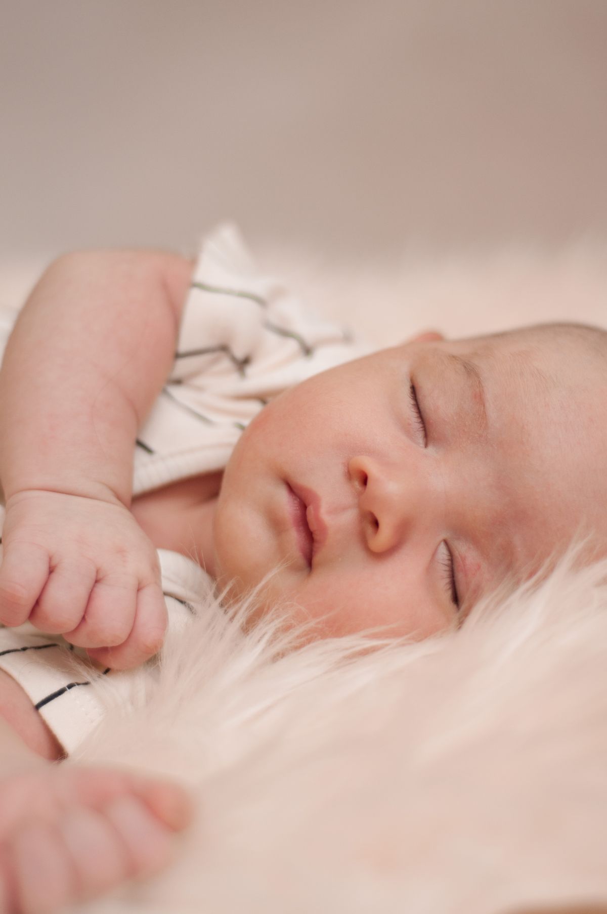 Baby sleeping restlessly on soft bedding during the 4-month sleep regression