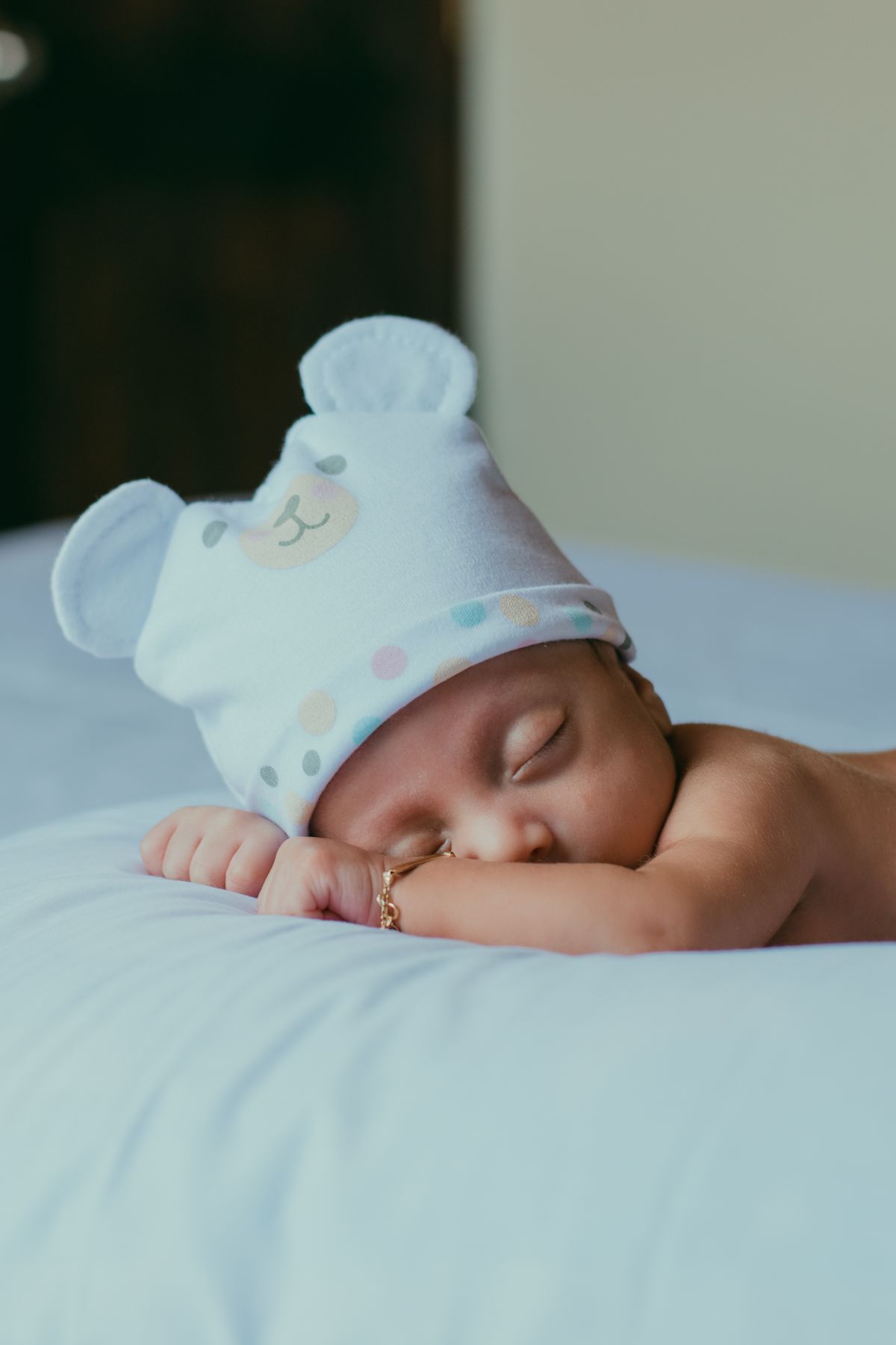 Four-month-old baby in a bear-eared hat sleeping soundly